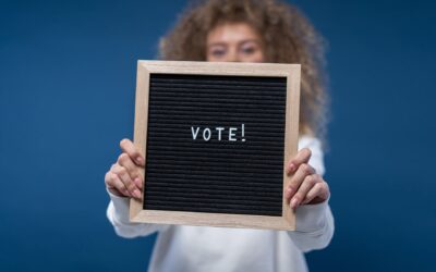 person holding a vote sign